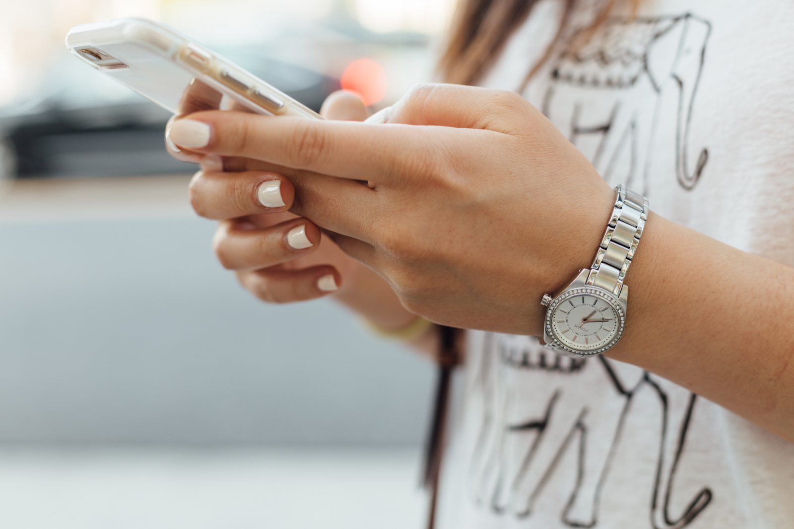 Young woman's hands holding smartphone